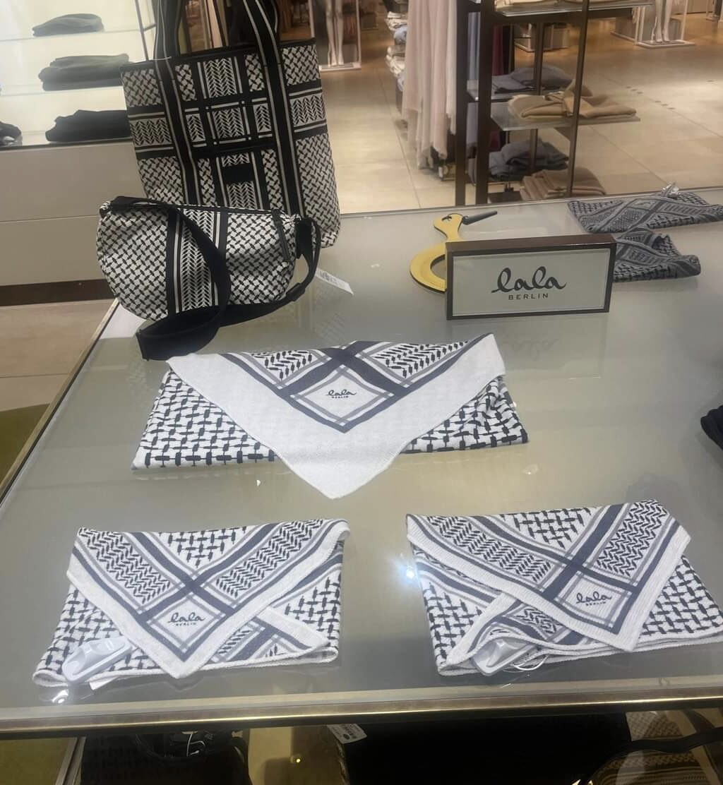 Another fashion stall in a department store with shawls and bags with black and white checker/grid motifs 